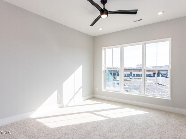 carpeted spare room featuring a ceiling fan, recessed lighting, visible vents, and baseboards