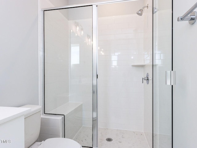 full bathroom with a shower stall and toilet