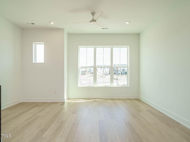 spare room featuring visible vents, recessed lighting, light wood-style flooring, and baseboards