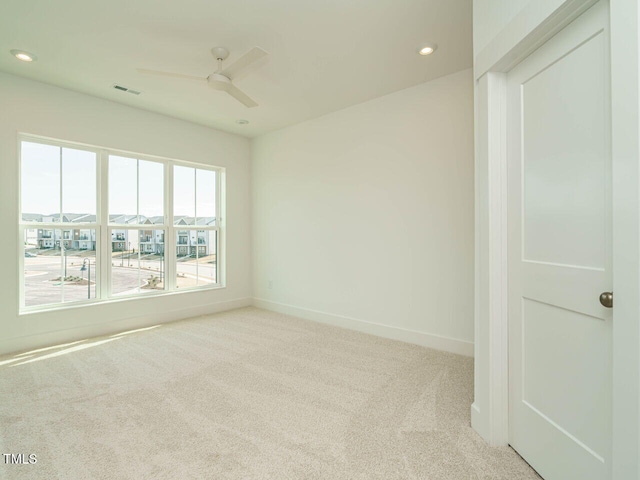 spare room featuring recessed lighting, carpet floors, a ceiling fan, visible vents, and baseboards