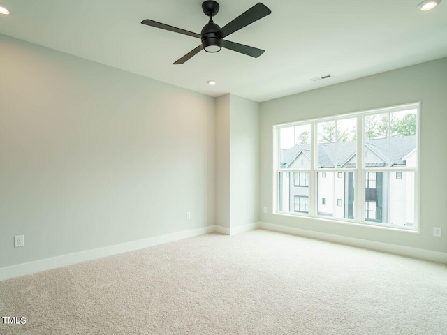 carpeted spare room with baseboards, visible vents, and recessed lighting