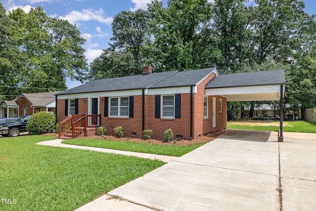 view of front of home with a front yard and a carport