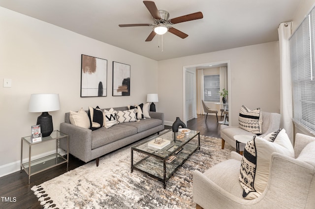 living room featuring dark hardwood / wood-style flooring and ceiling fan