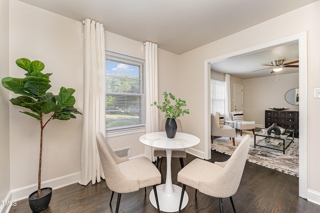 dining area with ceiling fan and dark hardwood / wood-style floors