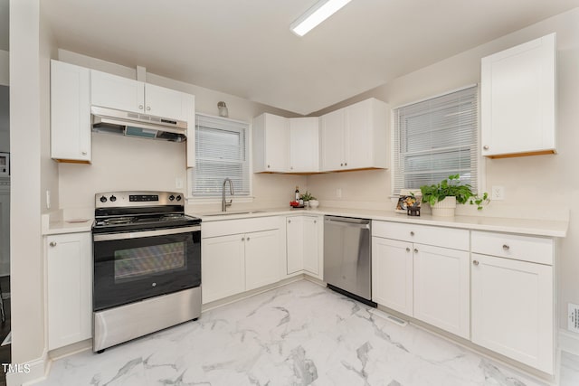 kitchen featuring stainless steel appliances, sink, and white cabinets