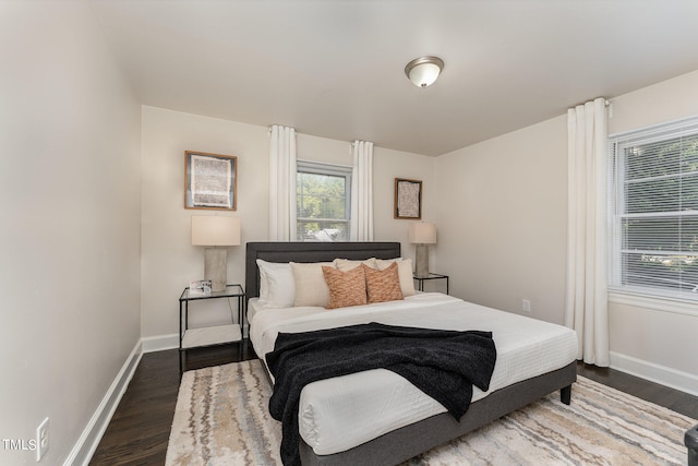 bedroom with dark wood-type flooring