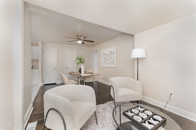 sitting room featuring dark hardwood / wood-style flooring and ceiling fan