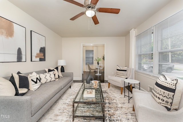 living room featuring ceiling fan and light hardwood / wood-style floors