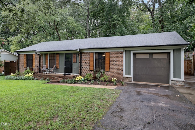 ranch-style house with a porch, a garage, and a front yard