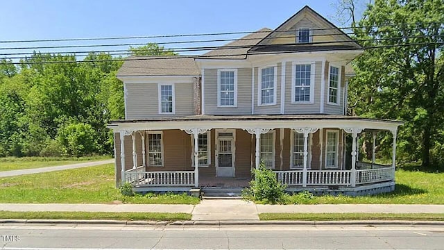 view of front of home with covered porch and a front yard