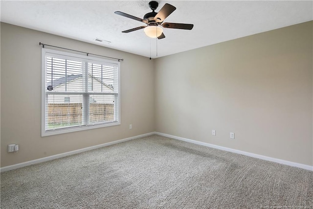 empty room featuring ceiling fan, carpet floors, and a textured ceiling