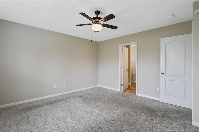 unfurnished bedroom with connected bathroom, light carpet, and ceiling fan