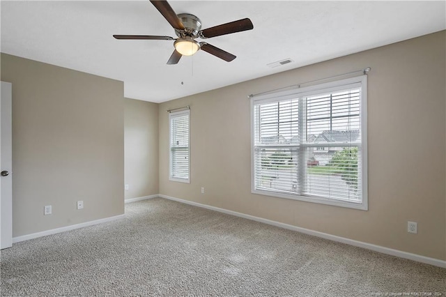 empty room with ceiling fan and carpet flooring