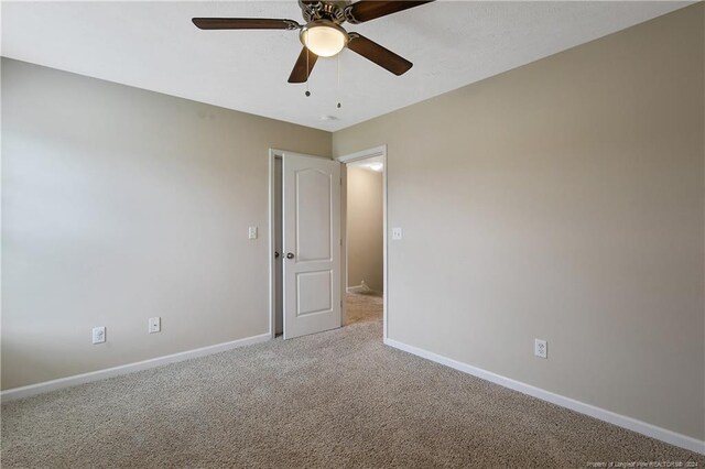 carpeted empty room with ceiling fan