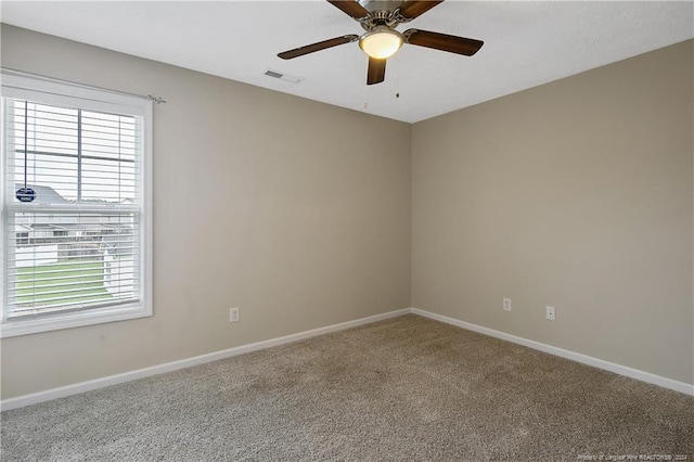 unfurnished room featuring ceiling fan and carpet