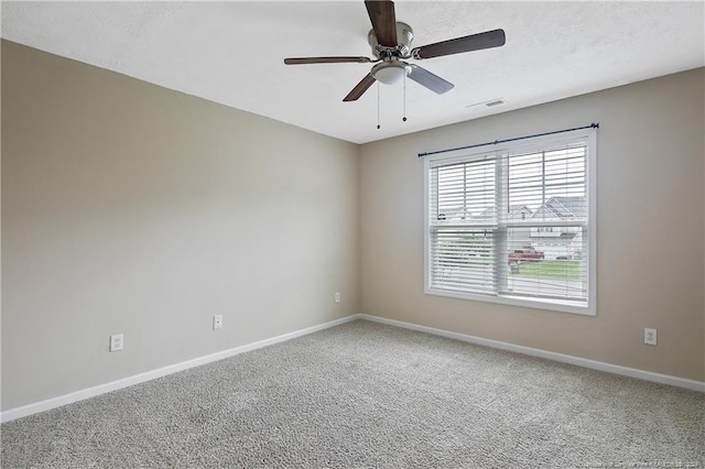 spare room featuring ceiling fan and carpet