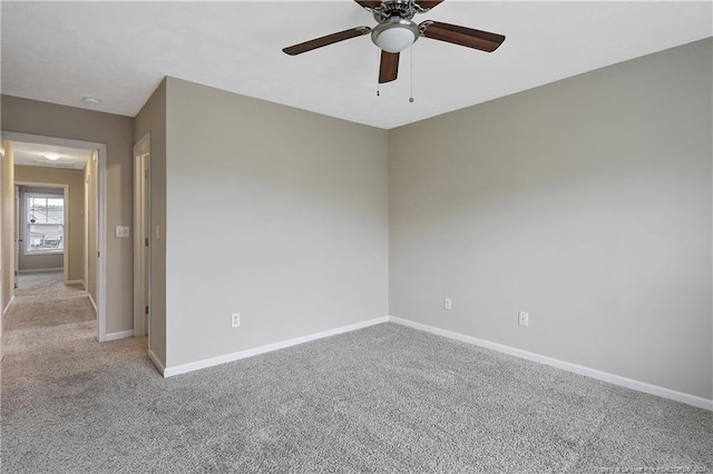 empty room with ceiling fan and light colored carpet