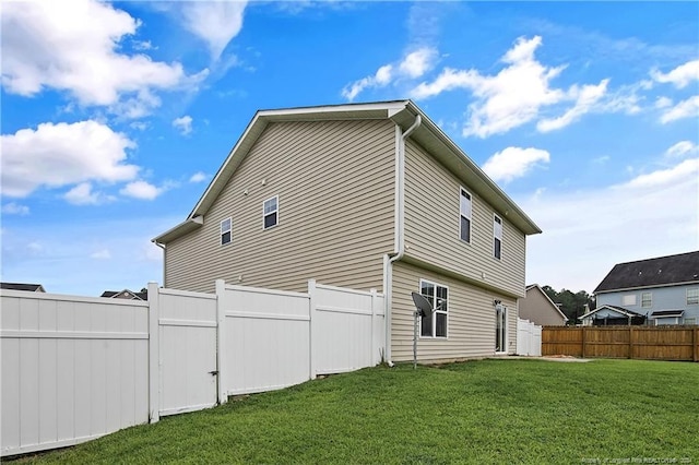 rear view of property with a yard