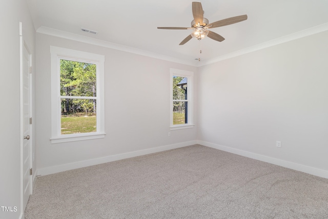 spare room featuring ornamental molding, carpet, and ceiling fan