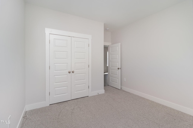 unfurnished bedroom with a closet and carpet