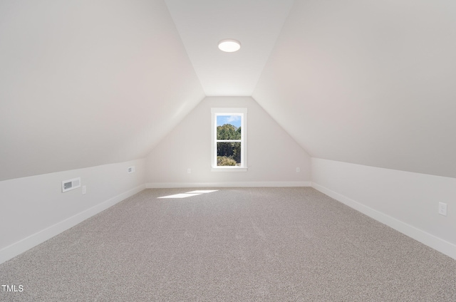 bonus room featuring lofted ceiling and carpet floors