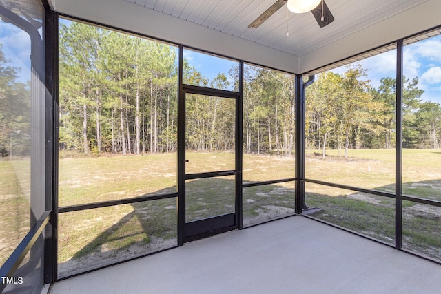 unfurnished sunroom featuring ceiling fan