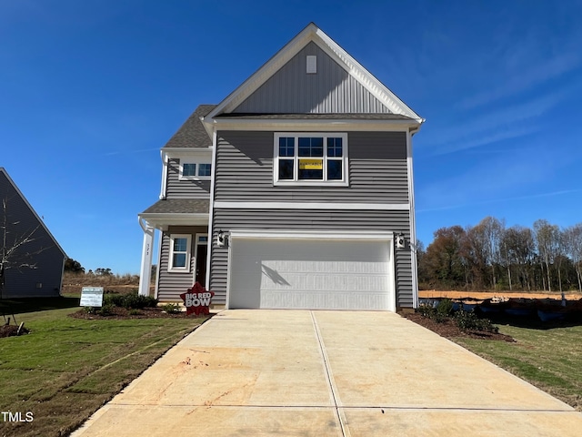 view of front of property with a garage and a front lawn