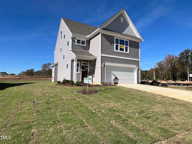 view of front facade with a garage and a front lawn