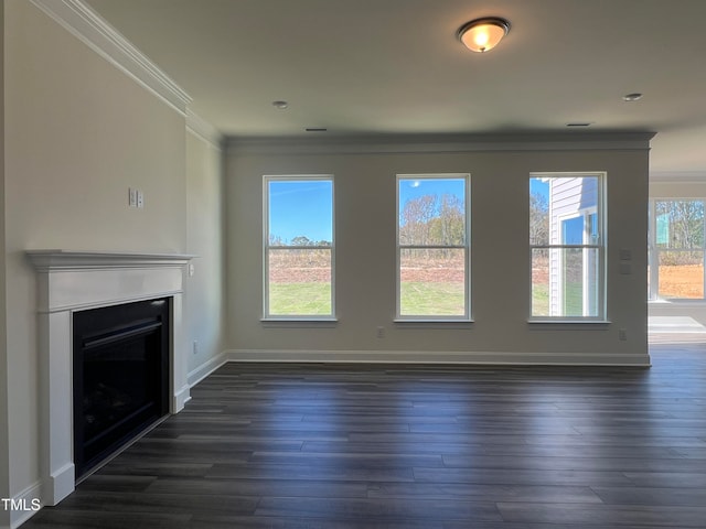 unfurnished living room with crown molding, a healthy amount of sunlight, and dark wood-type flooring