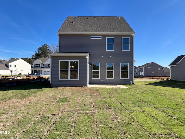 back of property featuring a yard and a patio area