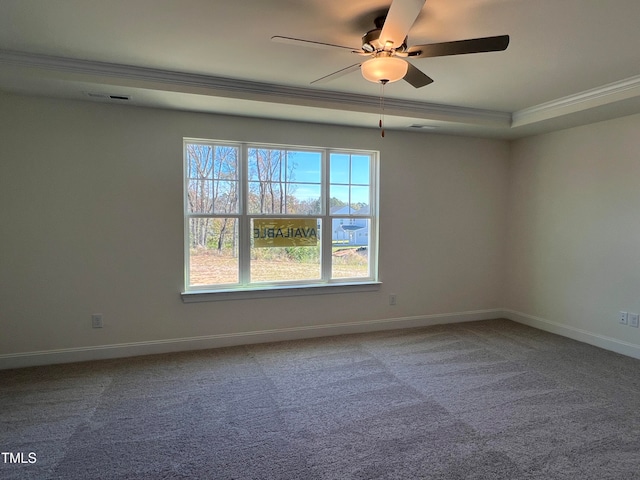 carpeted empty room featuring crown molding, ceiling fan, and a tray ceiling