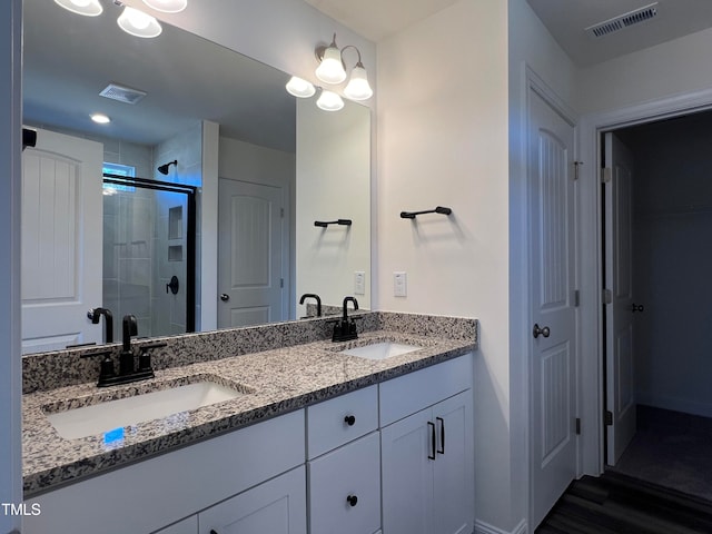 bathroom featuring vanity, a shower with door, and hardwood / wood-style floors