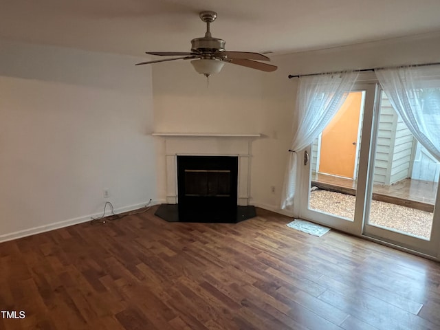 unfurnished living room with ceiling fan and wood-type flooring