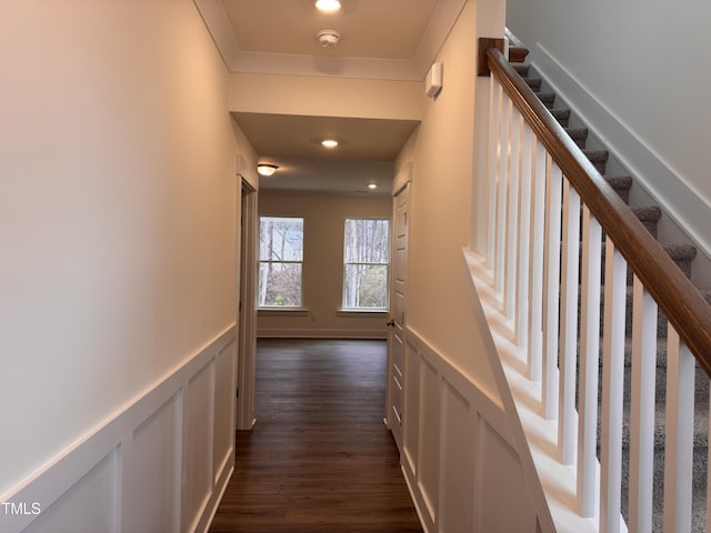 corridor featuring crown molding and dark hardwood / wood-style flooring