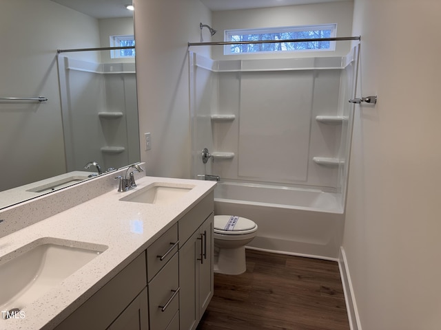 full bathroom with vanity, plenty of natural light, hardwood / wood-style floors, and toilet