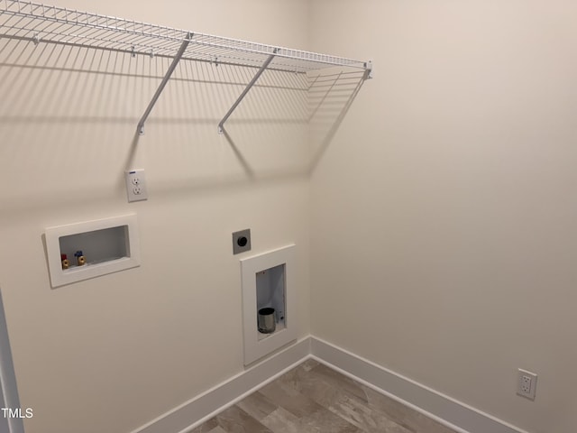 washroom featuring hookup for a washing machine, electric dryer hookup, and hardwood / wood-style flooring