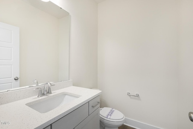 82 Gander Dr, Benson, NC 27504 - bathroom featuring vanity, toilet, and baseboards