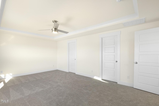 82 Gander Dr, Benson, NC 27504 - carpeted spare room featuring a tray ceiling, a ceiling fan, baseboards, and visible vents