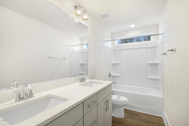 82 Gander Dr, Benson, NC 27504 - full bathroom with wood finished floors, toilet, visible vents, and a sink