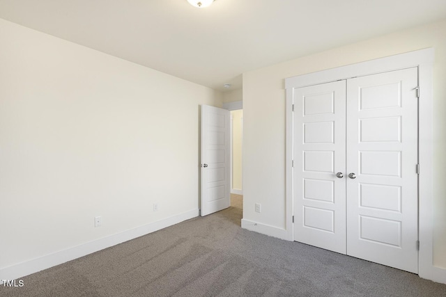 82 Gander Dr, Benson, NC 27504 - unfurnished bedroom featuring a closet, carpet flooring, and baseboards