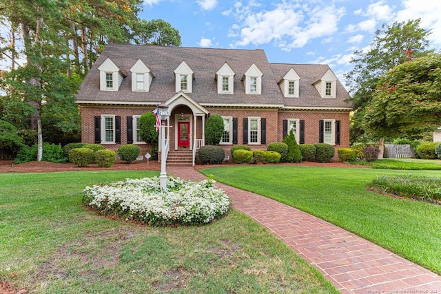 cape cod house with a front yard