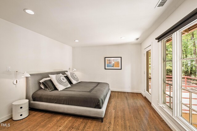 bedroom featuring access to exterior and hardwood / wood-style floors