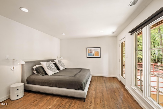 bedroom with baseboards, visible vents, wood finished floors, and recessed lighting