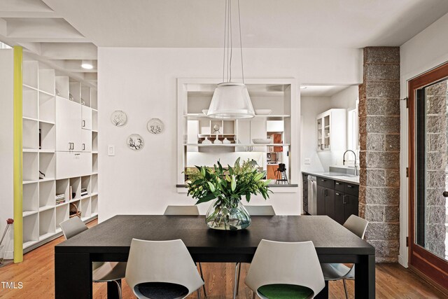 dining space featuring light hardwood / wood-style flooring and sink