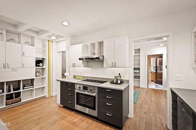 kitchen with light countertops, light wood finished floors, under cabinet range hood, stainless steel appliances, and white cabinets