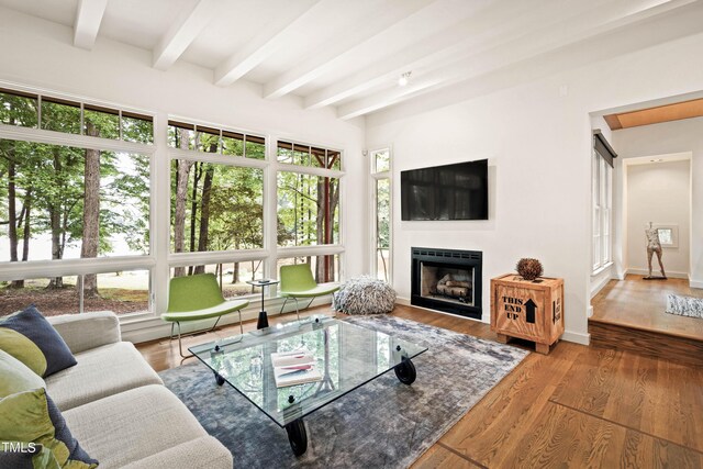 living room featuring beamed ceiling and hardwood / wood-style flooring