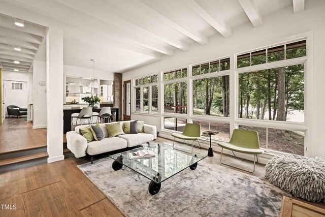 sunroom featuring beamed ceiling