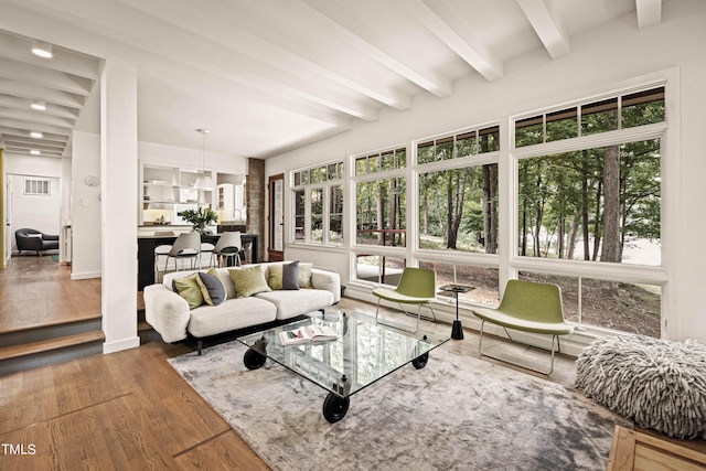 interior space with beamed ceiling and wood finished floors