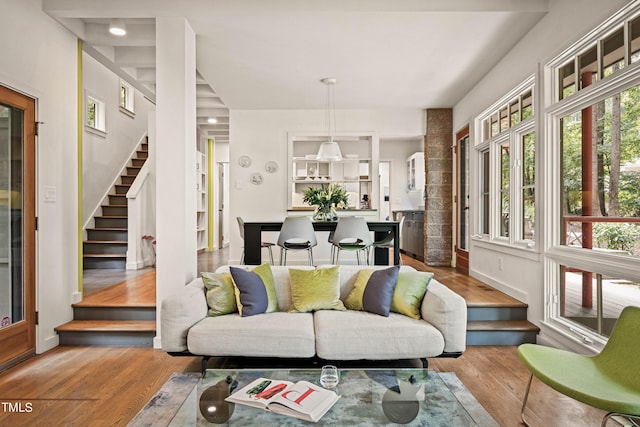 living area featuring stairs and wood finished floors