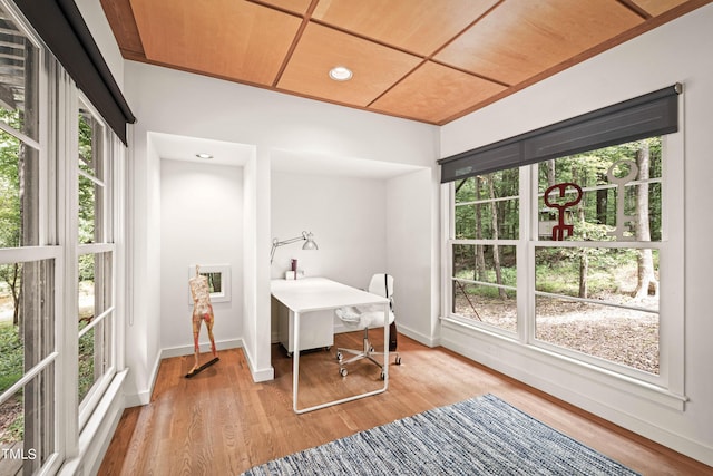 home office featuring baseboards and wood finished floors